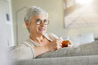 © goodluz - Mature woman drinking hot tea, relaxing time at home