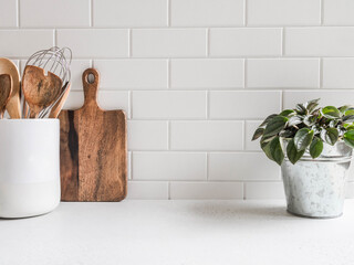Kitchen background with kitchen utensils and houseplant
