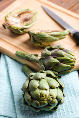 Wall Mural - Fresh artichoke on a cutting board