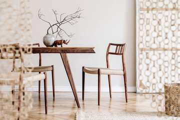 Stylish and beige interior of dining room with design wooden table and chairs, vase with flowers, elegant and rattan accessories. Korean style of home decor. Wooden parquet. Template.