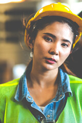 Wall Mural - Portrait of beautiful Asian woman serious civil engineer wearing uniform and hardhats working at industrial factory. Engineering and architecture concept