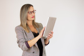 Businesswoman holding tablet in hands isolated