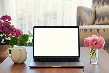 Wall Mural - Living room with modern beige textile couch and laptop on wood textured table, natural light. House plants in cozy interior. Background, copy space/