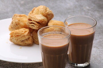 Wall Mural - indian khari or kharee or salty Puff Pastry Snacks, served with indian hot tea.