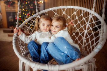 Wall Mural - children in the new year photo Studio, new year is coming, family, sisters, funny girls hug