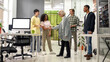 © Svitlana - Full length shot of cheerful young team greeting new employee, Aged woman, senior intern at her new job in the modern office