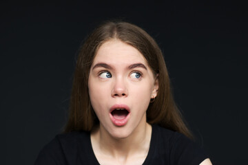 portrait of a young beautiful girl with a surprised face