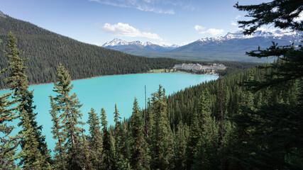 Wall Mural - Wonderful alpine lookout with turquoise glacier lake and castle like hotel on its bank, shot at Lake Louise, Banff National Park, Canada