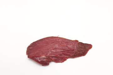 Wall Mural - Large piece of meat on a light background. Beef tenderloin. Close-up, selective focus, copy space