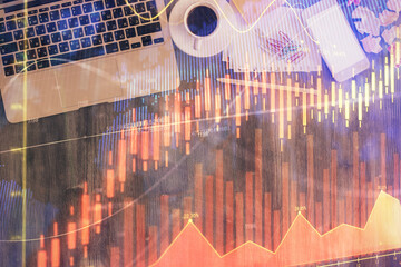 Financial market graph and top view computer on the desktop background. Double exposure. Investment concept.