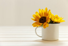 Mockup With Enamel Cup And Sunflowers. Empty White Cup With Space For Text, Print Or Pattern. White Background.