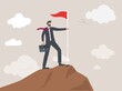 © katakari - Confidence businessman standing proudly with victory flag on high mountain peak up hill, business goal achievement, success career development or motivation and work or project accomplishment concept.