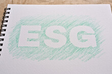 There Is A Sketchbook With The Word "ESG" Stenciled On It. It Is An Acronym That Stands For Environmental, Social And Governance.
