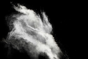 Freeze motion of white powder explosions isolated on black background