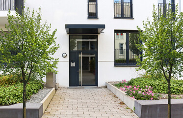 Wall Mural - View to entrance door of a modern residential building with new apartments in the city