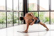 © Margo Basarab - Yoga men workout in studio, training in front of a window