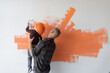 © Andrii Lysenko - repairs his house, the father keeps his son and he helps him paint the wall with a roller,