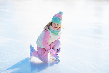 Wall Mural - Child skating on natural ice. Kids with skates.