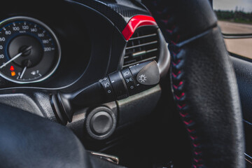 Switch off lights in a car. close-up Car integrated turning indicator with headlight switch toggle.