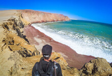 Tourist Looking At The Ocean At Playa Roja ( Red Beach ) In The Coast Of Paracas - Peru