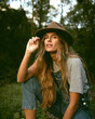 © Alvaro - Girl in the woods wearing denim overalls and a cowboy fedora hat. Autumn vives.