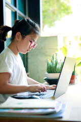 asian children working on computer laptop at home