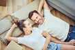 © baranq - Happy couple moving to new home lying on the floor