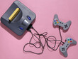 © splitov27 - Retro video game console with joysticks on pink background. Top view