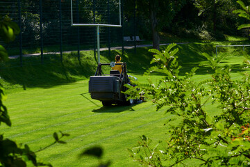 care of the football field on a lawn mower