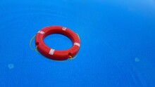 Red Life Buoy Floating In The Pool