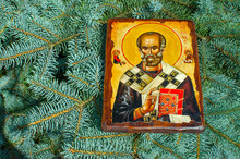 UKRAINE, ODESSA REGION, VILLAGE PETRODOLINSKOE – JUNE, 30, 2019: Icon Of St. Nicholas On The Background Of Branches Of Blue Spruce.