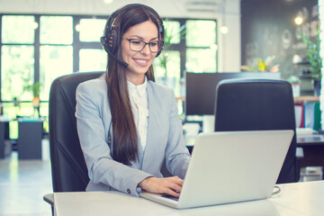 Young businesswoman working on laptop in modern office