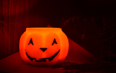 Festive orange candle pumpkin at night in the hands. Magic. Shine. Halloween. postcard, headband.