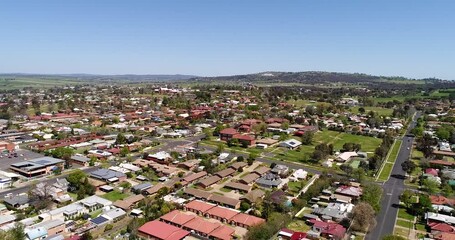 Canvas Print - Mt Panorama hill on motorsport race track – aerial flying from Bathurst in 4k.
