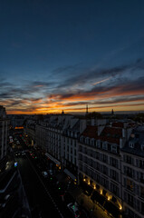 Fototapete - Beautiful sunset over the city of Paris, France with Eiffel Tower and Invalides above the roofs