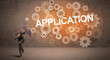 © ra2 studio - Businessman defending with umbrella from APPLICATION inscription, technology concept