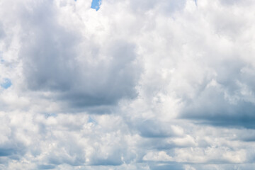 Isolated big white large cloud formations closeup in blue sky cloudscape skyscape looking up during day in Tampa, Florida