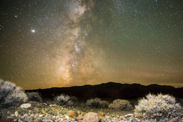 the milky way galaxy rising over the desert landscape in death valley national park (california).
