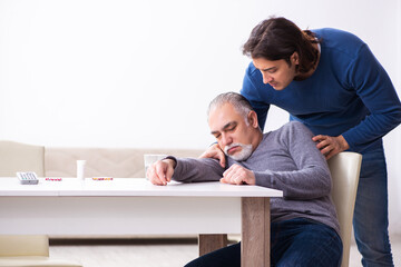 Wall Mural - Grandfather and grandson in first aid concept