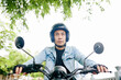 © DragonImages - Young Vietnamese motorcyclist concentrated on road when riding fast in the city