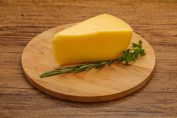 Hard cheese piece served rosemary