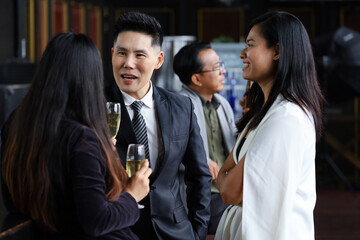 Executive business people greeting and meeting with partner or friends, alcohol drink hang out party and smile cheers together after work