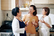 © DragonImages - Group of senior Asian women drinking champagne in kitchen at home party