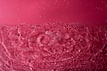 Wall Mural - splash of water on a red background. Abstract wallpaper