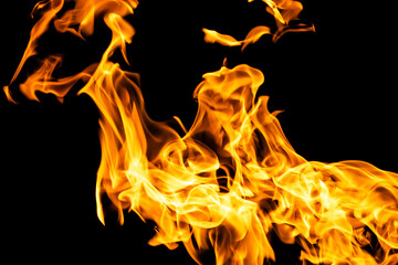 Fire flames on black background isolated. Burning gas or gasoline burns with fire and flames. Flaming burning sparks close-up, fire patterns. Infernal glow of fire in the dark with copy-space