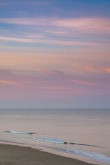 Poster - beautiful sunset over the ocean with colorful sky and small waves