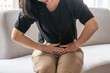© Chinnapong - Abdominal pain in woman with stomachache illness from menstruation cramps, stomach cancer, irritable bowel syndrome, pelvic discomfort, Indigestion, Diarrhea or GERD (gastro-esophageal reflux disease)