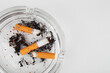 © Богдан Стеблянко - Сigarette butts in an ashtray on a white background, top view. Place for your text.