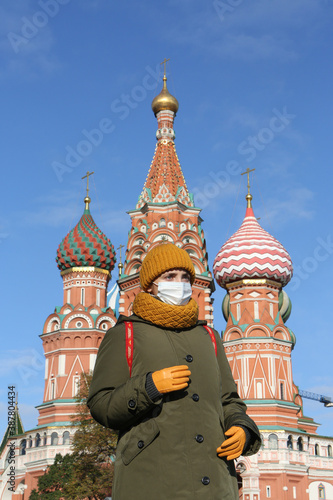 Covid-19, coronavirus in Russia. Quarantine in Moscow city. Epidemic, pandemic covid-19, coronavirus. Russian woman in medical mask at Red Square. Moscow Kremlin, Saint Basil\'s Cathedral. Corona virus