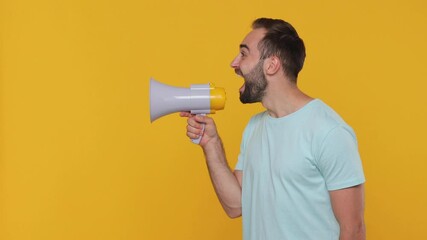 Wall Mural - Side profile view fun man 20s years old in basic casual blue t-shirt isolated on yellow background studio. People lifestyle concept. Looking aside scream in megaphone announces discounts sale Hurry up